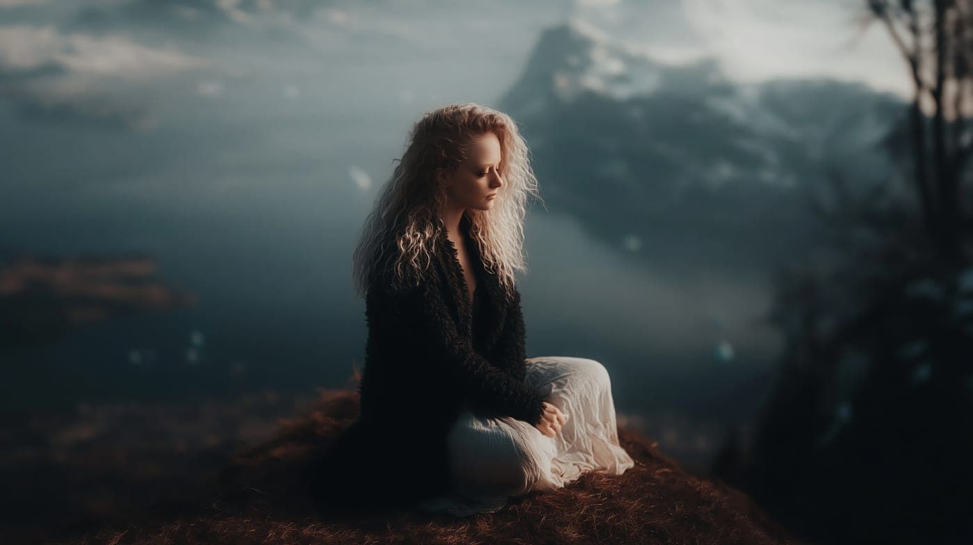 Woman in a misty mountain landscape at dusk